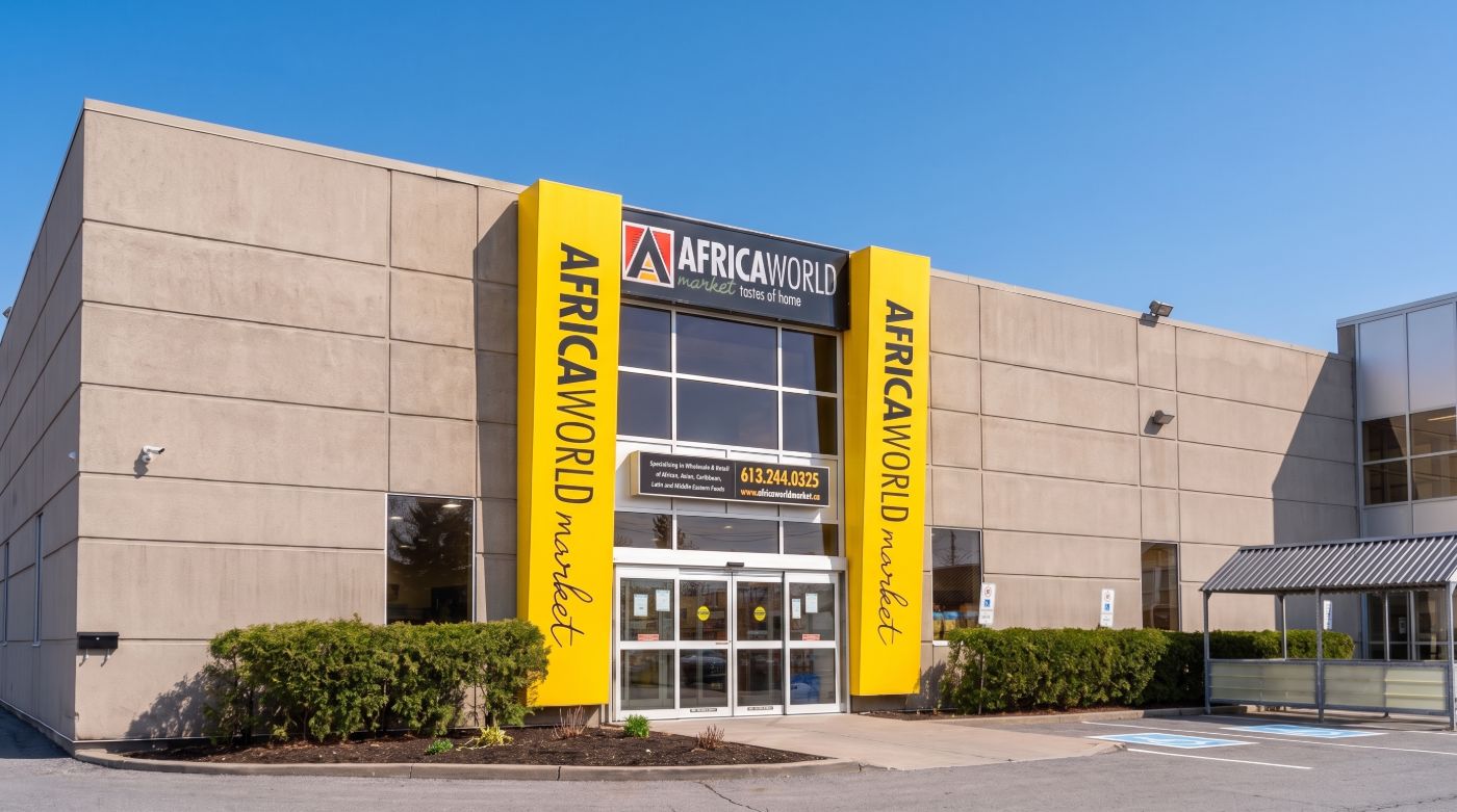 The Africa World Market storefront on Cyrville Road, with yellow pillars and the store sign above the glass entrance