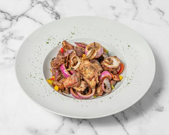 Charcoal-grilled goat meat with red onions and peppers